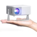 AKIYO O1 Pro mini projector balanced on an open palm